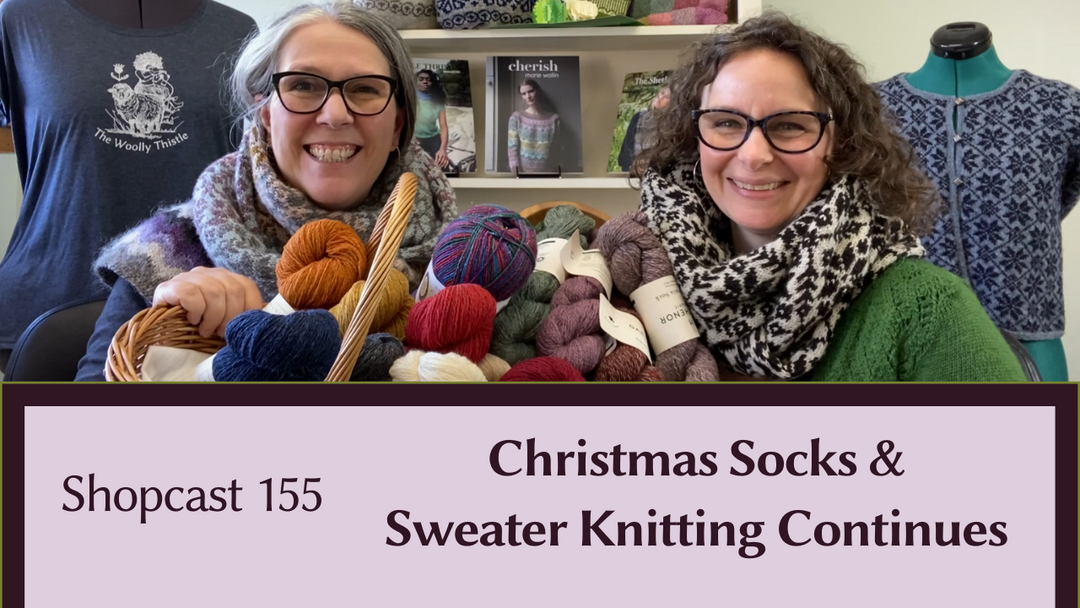 Corinne and Maggie sit with baskets of yarn for Shopcast episode 155.