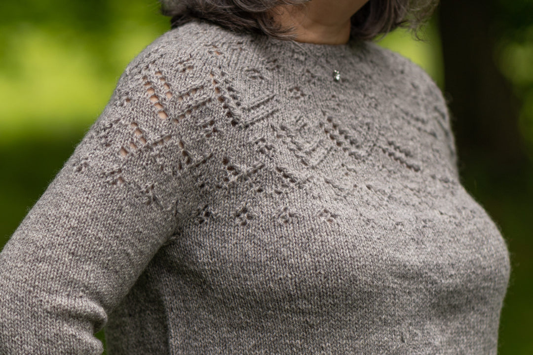 Beauly Sweater knit with Rauma Strikkegarn in color 104. Close up of lace yoke.