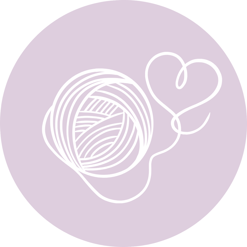 White outline of a ball of yarn and a heart on a purple circle, representing a yarn  included in the Box, which has not yet been revealed. 