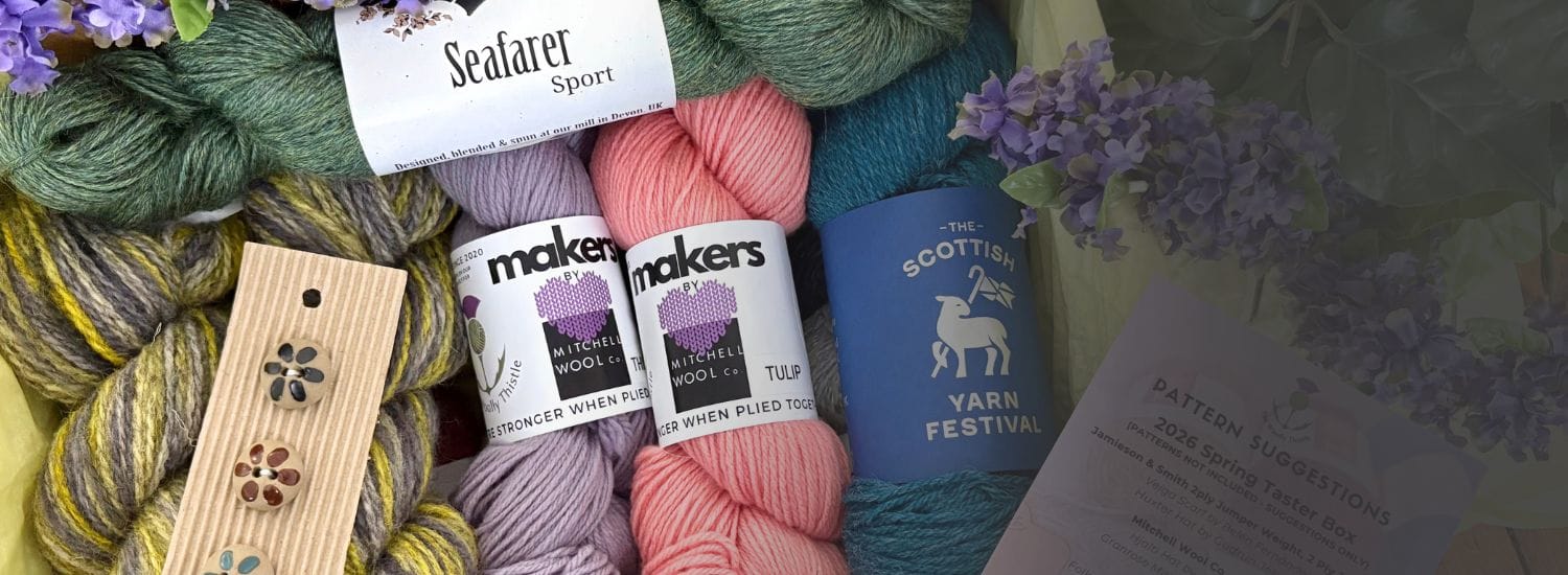 Collection of yarns and buttons that are included in the Spring Taster Box. Visible yarn labels include Seafarer Sport, Mithcell Wool Co, and The Scottish Yarn Festival.