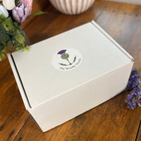 2026 Spring Taster Box represented by large white box with The Woolly Thistle logo sticker.