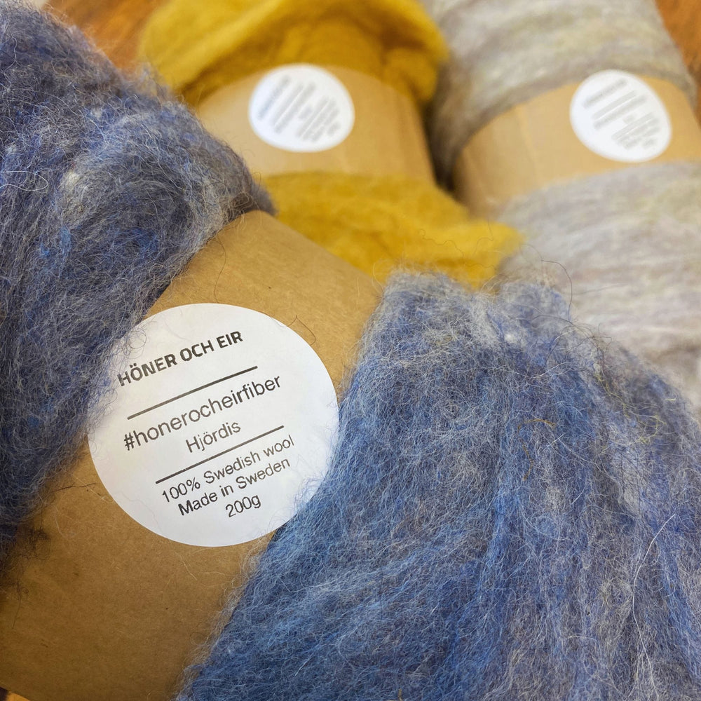 Close-up of fiber batts with label reading name and 100% Swedish Wool, Made in Sweden 200g