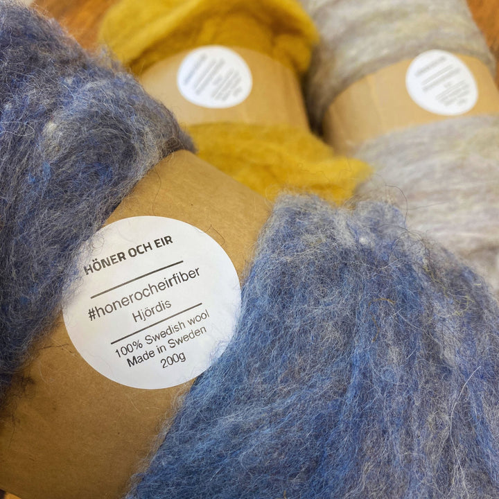 Close-up of fiber batts with label reading name and 100% Swedish Wool, Made in Sweden 200g