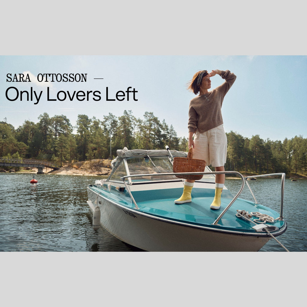 Spread from Laine Issue 28 Magazine showing woman on a boat wearing handknit sweater, with trees and water in the background, featuring the text 'Sara Ottosson - Only Lovers Left'.