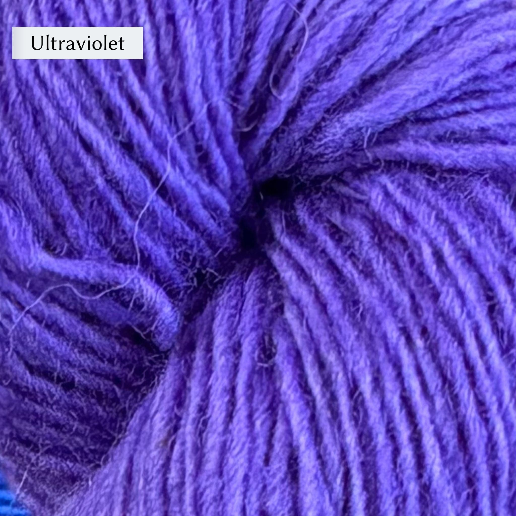 Close-up of Lichen & Lace Rustic Sport  yarn in "ultraviolet" colorway yarn which is a vibrant purple