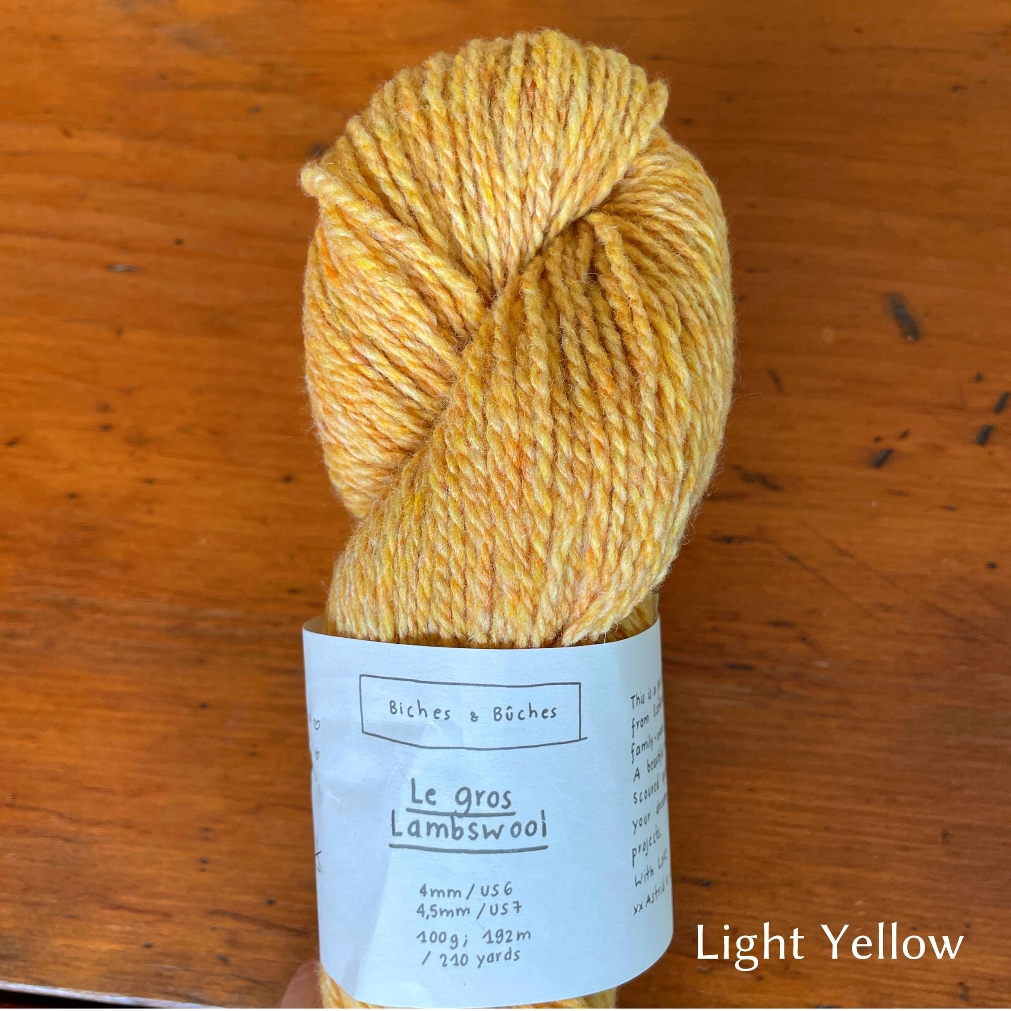 Skein of  Biches & Buches Les Gros Yarn in yellow with hints of orange.