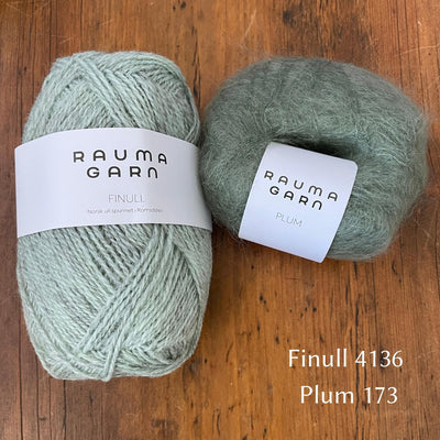 Ball of Rauma Finullgarn yarn in heathered light green/blue with coordinating Plum yarn 