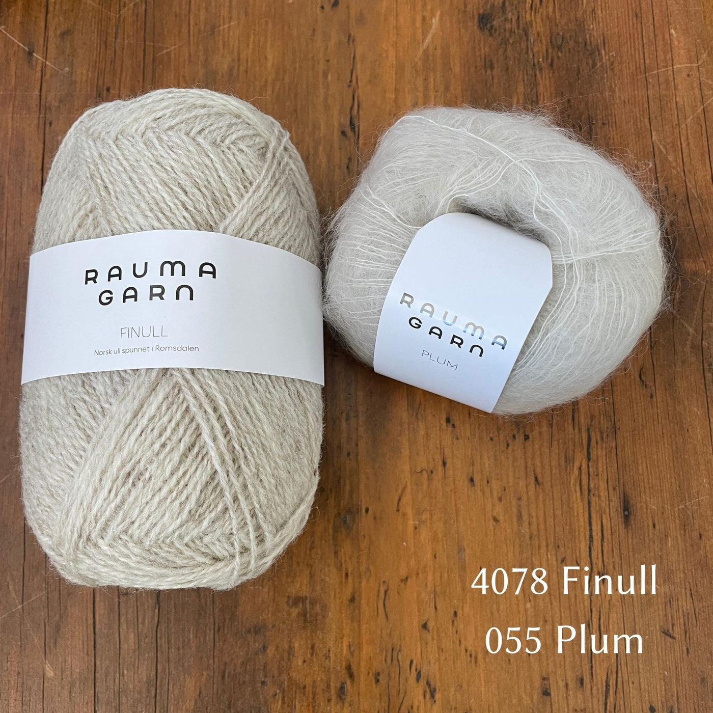 Ball of Rauma Finullgarn yarn in heathered oatmeal / cream with coordinating Plum yarn 