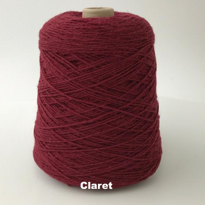 Cone of Frangipani 5-ply Guernsey Wool Yarn in colorway Claret, a shade of red.