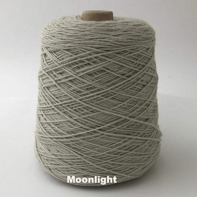 Cone of Frangipani 5-ply Guernsey Wool Yarn in colorway Moonlight, a shade of gray.