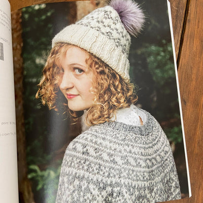 Page of Nordic Knitting Primer book with woman wearing grey and cream color work hat and sweater.