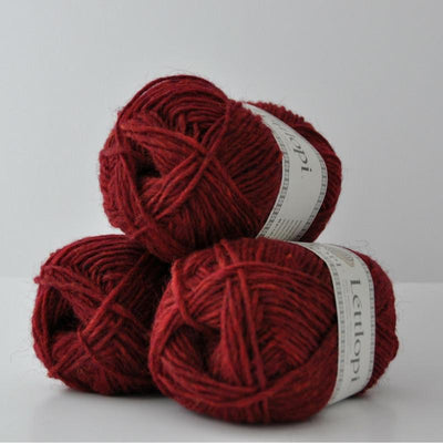 Ball of Lettlopi in colorway 1409 - garnet red heather.