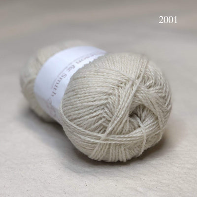 A ball of Jamieson & Smith Shetland Supreme, a fingering weight wool yarn, in color 2001, white