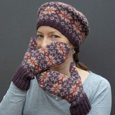 Woman wearing fair isle tam and mittens.