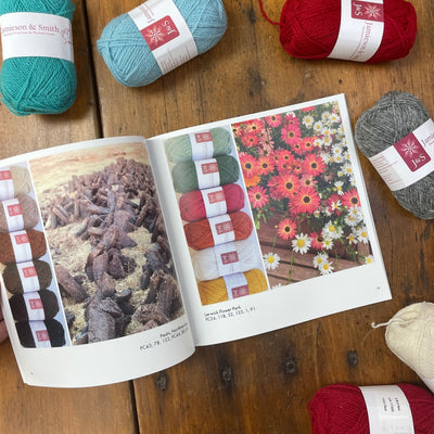 Wirsit Inspo Volume 1 from Jamieson & Smith. Inside pages of book are shown two photos with yarn colors paired lined up on left. Yarn is Jamieson & Smith 2ply Jumper Weight yarn. 