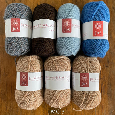 7 balls of J&S yarn in beige brown and three tones of blue