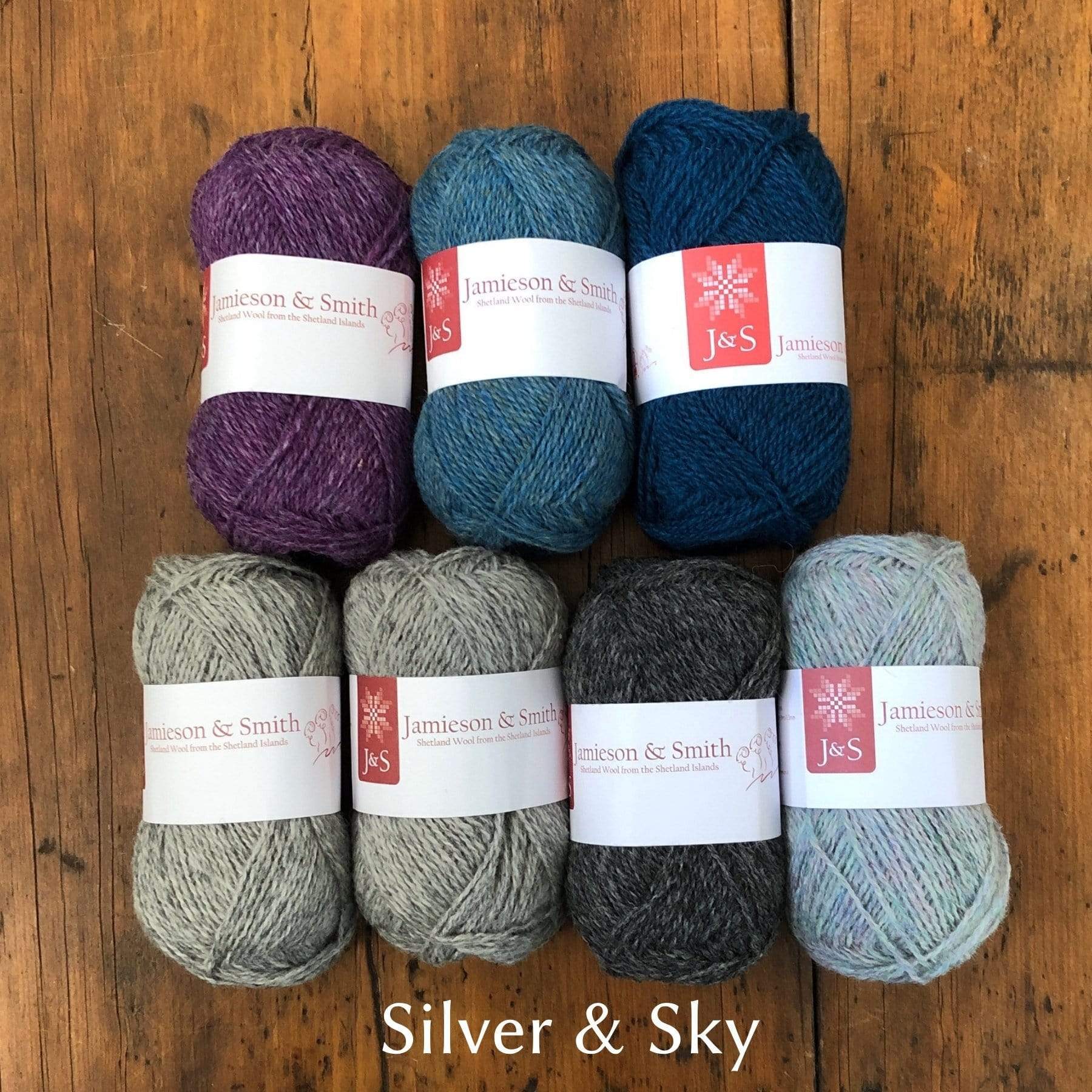 Jamieson & Smith Yarns in greys, light blue, medium blue, navy blue and purple.
