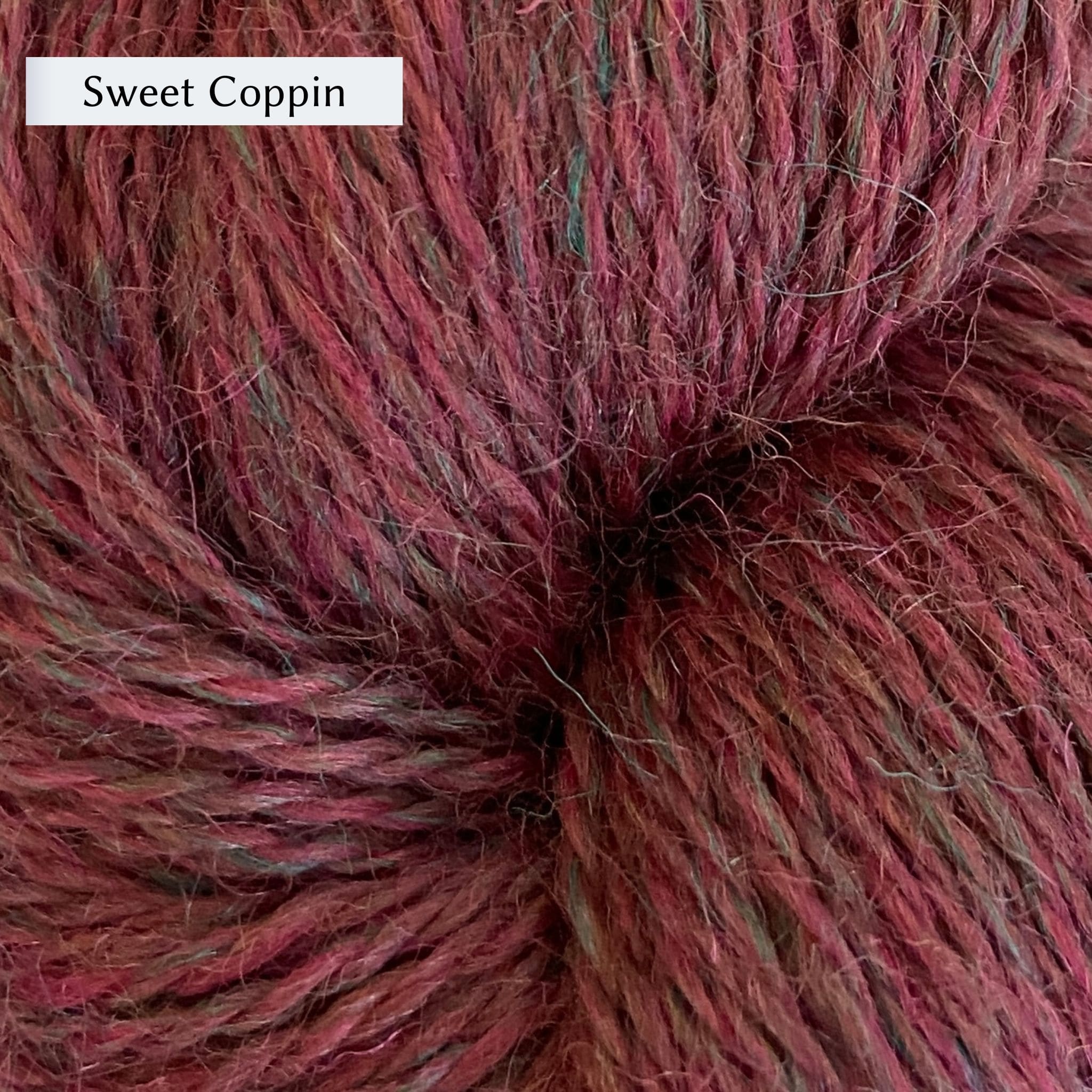 John Arbon Appledore DK, a DK weight British yarn, in color Sweet Coppin, a burgundry red with green heathering