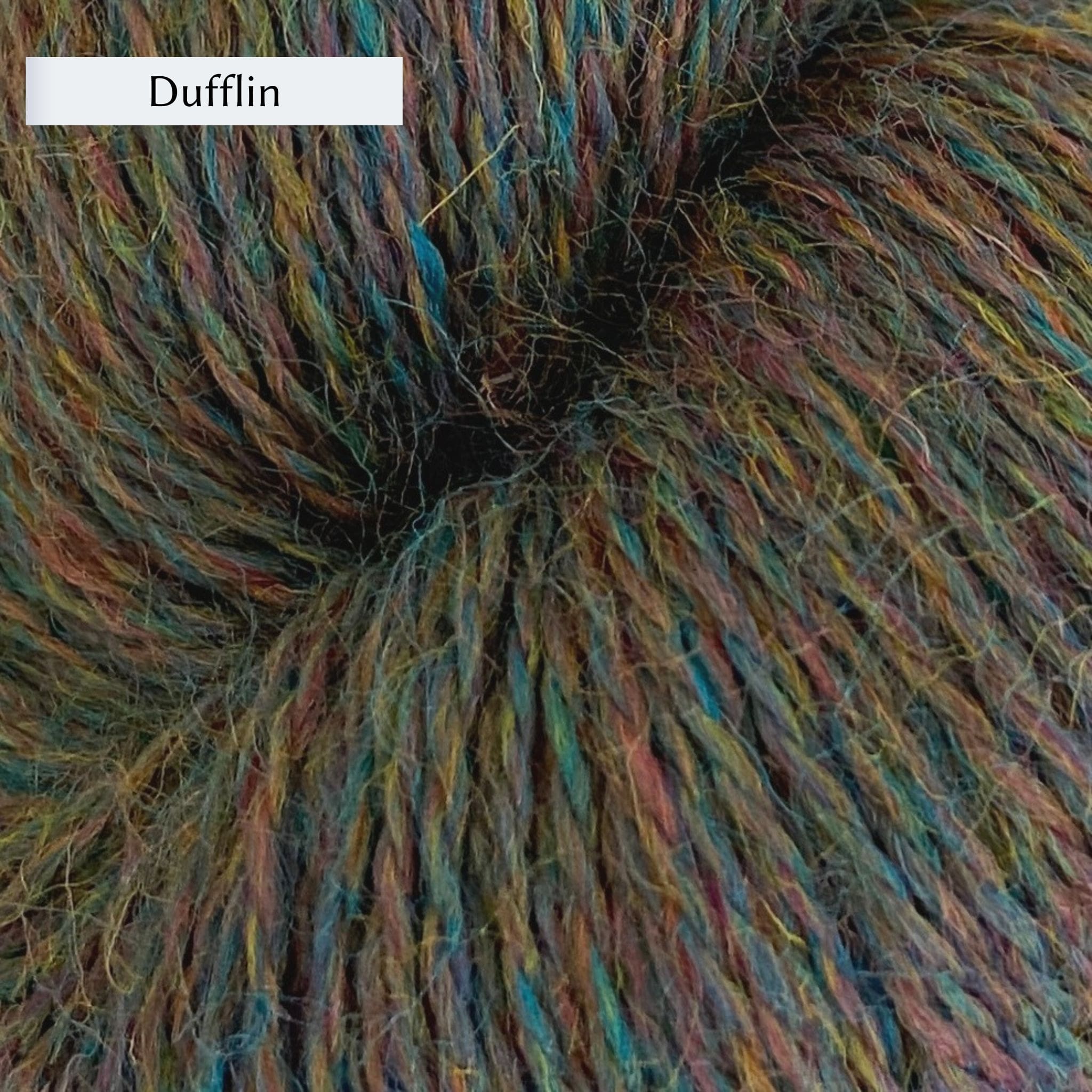 John Arbon Appledore DK, a DK weight British yarn, in color Dufflin, a mottled green with blue, red, and yellow 