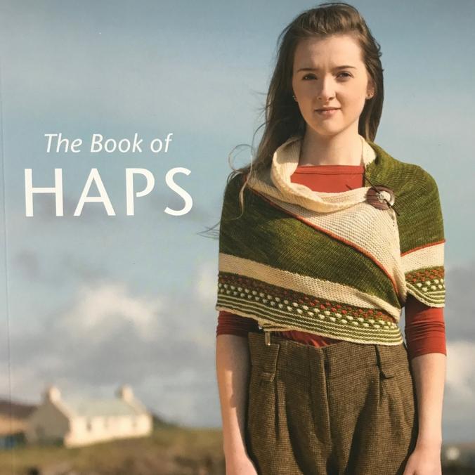 Cover of The Book of Haps by Kate Davies featuring a young woman wearing a Hap.