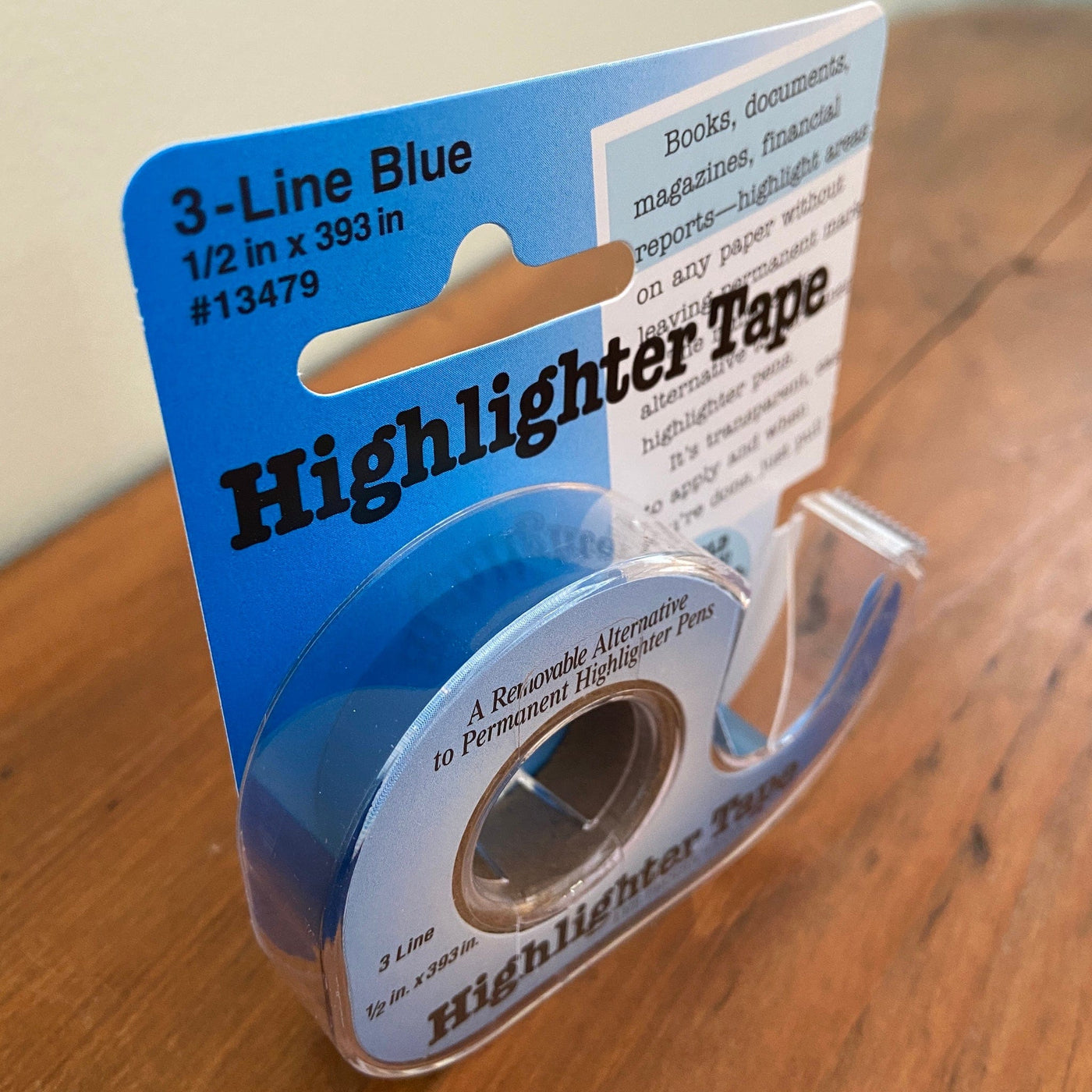 Package of blue highlighter tape sitting on table.