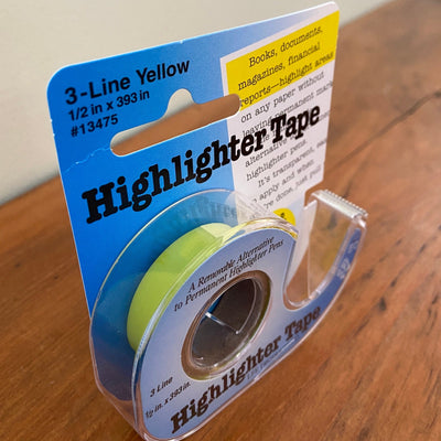 Package of yellow highlighter tape sitting on table.