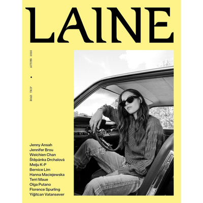 Cover 2 of Laine Magazine Issue 15 Autumn 2022 Yellow Cover 2 with woman sitting in seat of car wearing jeans and sweater.
