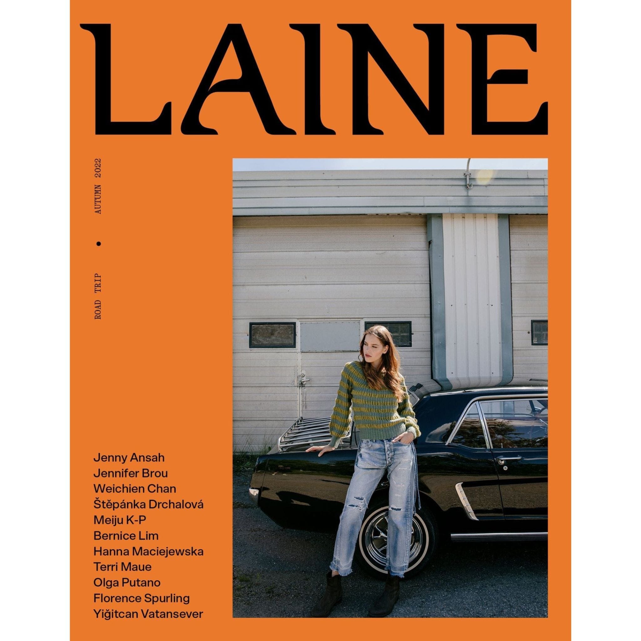 Cover of Laine Magazine Issue 15 Autumn 2022 Orange Cover with woman standing in front of car with jeans and sweater.