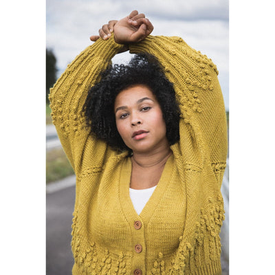 Inside Laine Magazine Issue 15 Autumn 2022 side aerial view of woman wearing off yellow cardigan with texture.