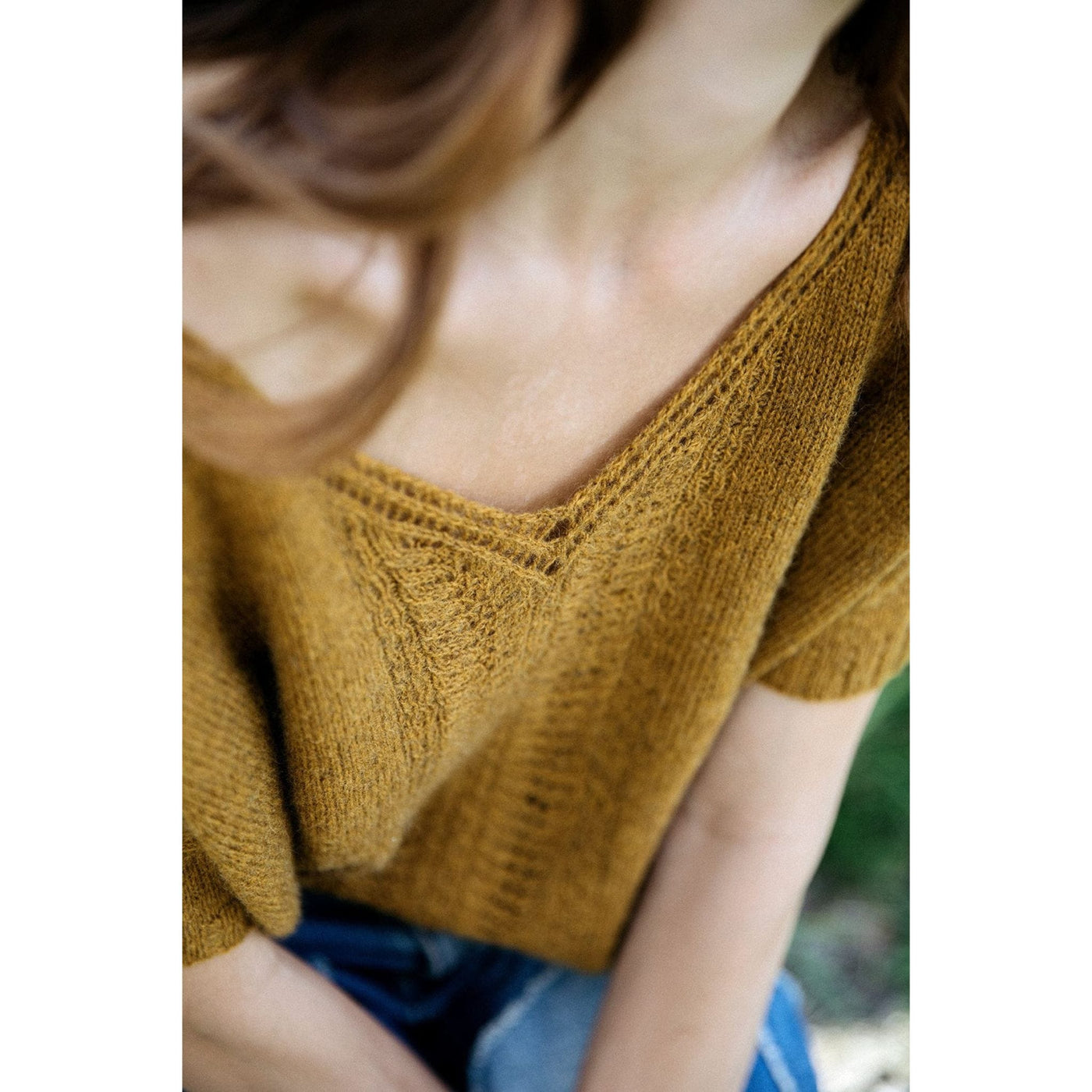 Inside Laine Magazine Issue 15 Autumn 2022 aerial view of woman wearing off yellow/gold short sleeve sweater.