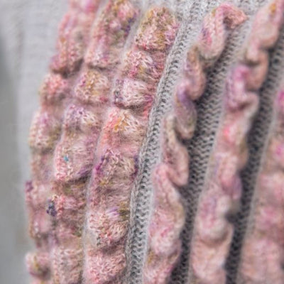 Page shown from book, Neons & Neutrals: A Knitwear Collection Curated by Aimée Gille of La Bien Aimée. Book is published by Laine. Page shows knit details, pink ruffles.