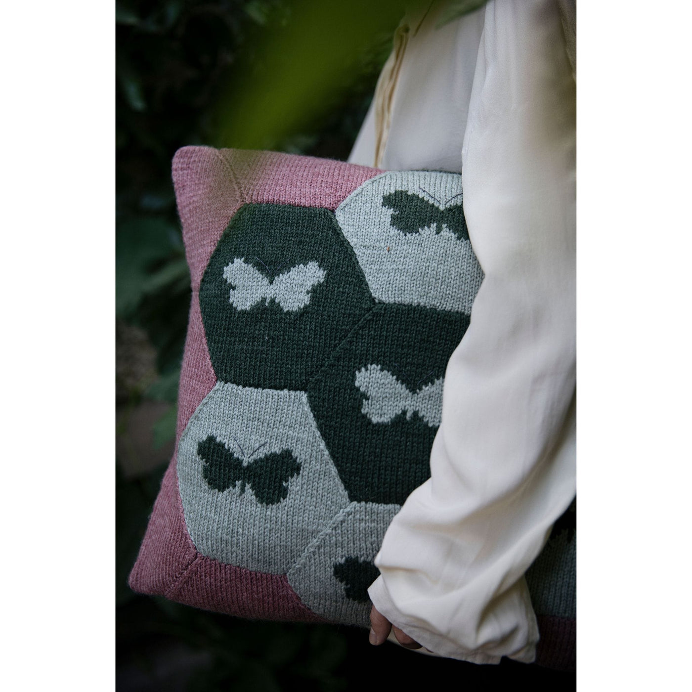 Page from The Knitted Fabric by Dee Hardwicke showing a pillow with hexagons and butterflies