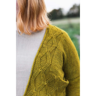 The Woolly Thistle Worsted – A Knitwear Collection Curated by Aimée Gille of La Bien Aimée published by Laine woman wearing mustard yellow knitted cardigan