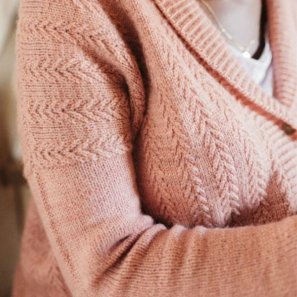 Model wearing pink textured knit sweater.