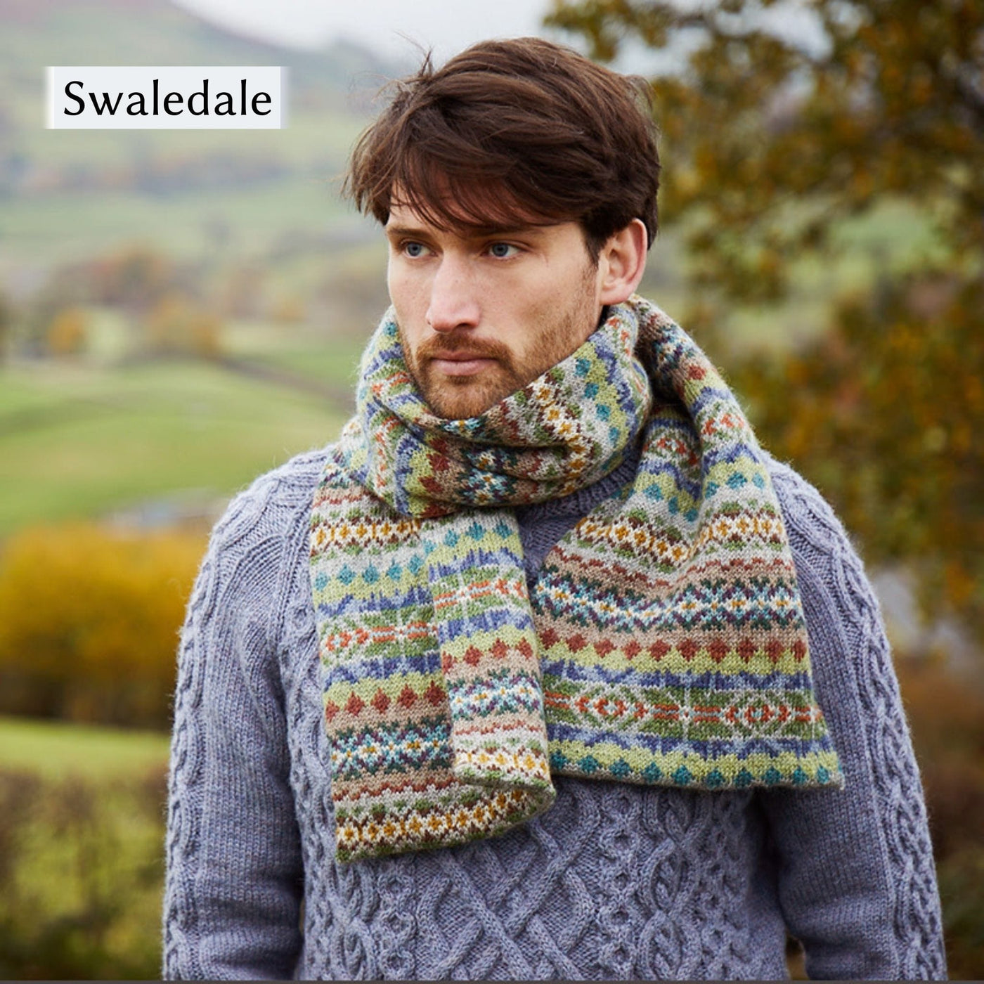 Male model wearing Swaledale, an all over colorwork scarf, from Cumbria Book by Mare Wallin color