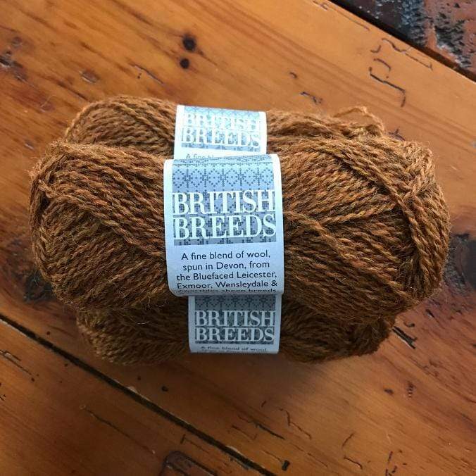Ball of Marie Wallin's British Breeds yarn in colorway Russet, a rust color.