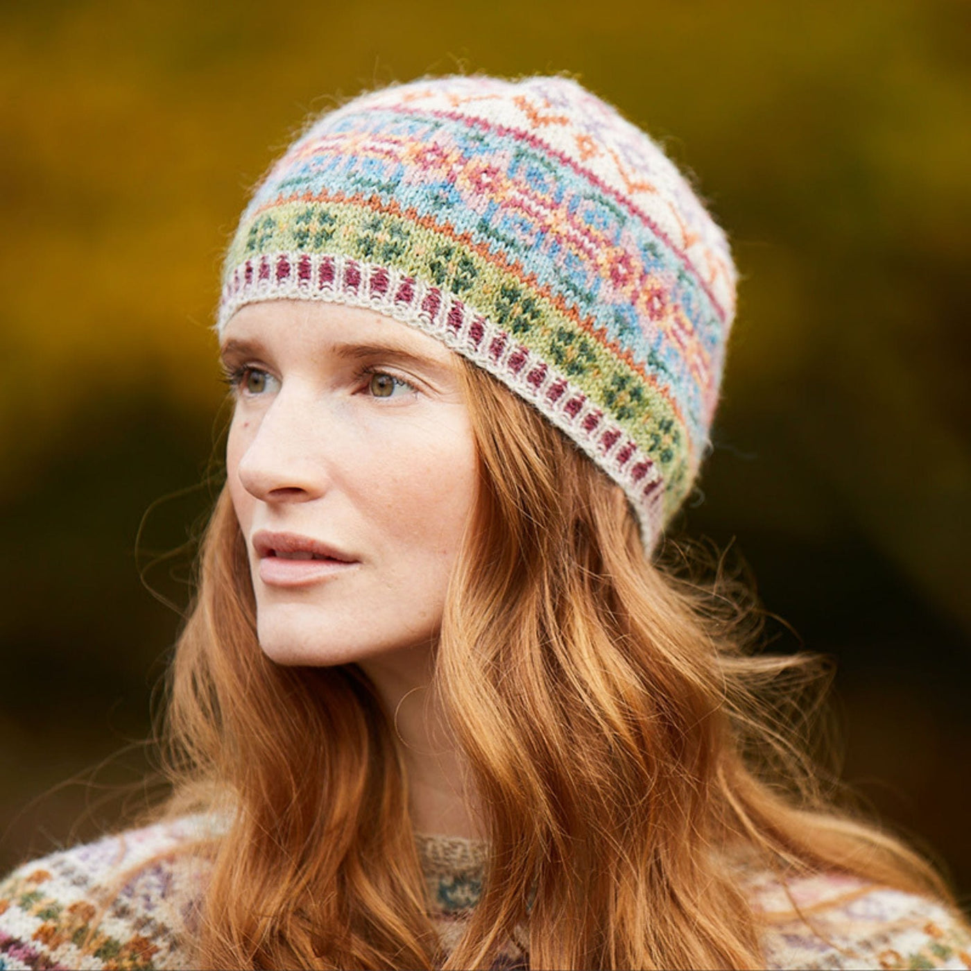 Female model wearing Tarn Tam, an allover colorwork hat designed by Marie Wallin in her new collection, Cumbria