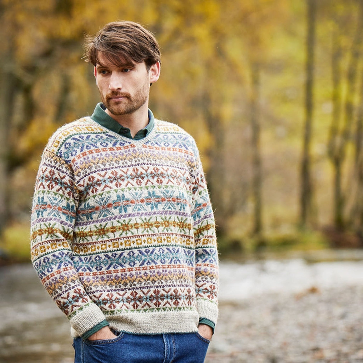 Male model wearing Troutbeck, an allover colorwork sweater designed by Marie Wallin in her new collection, Cumbria. Sweater main color is Raw