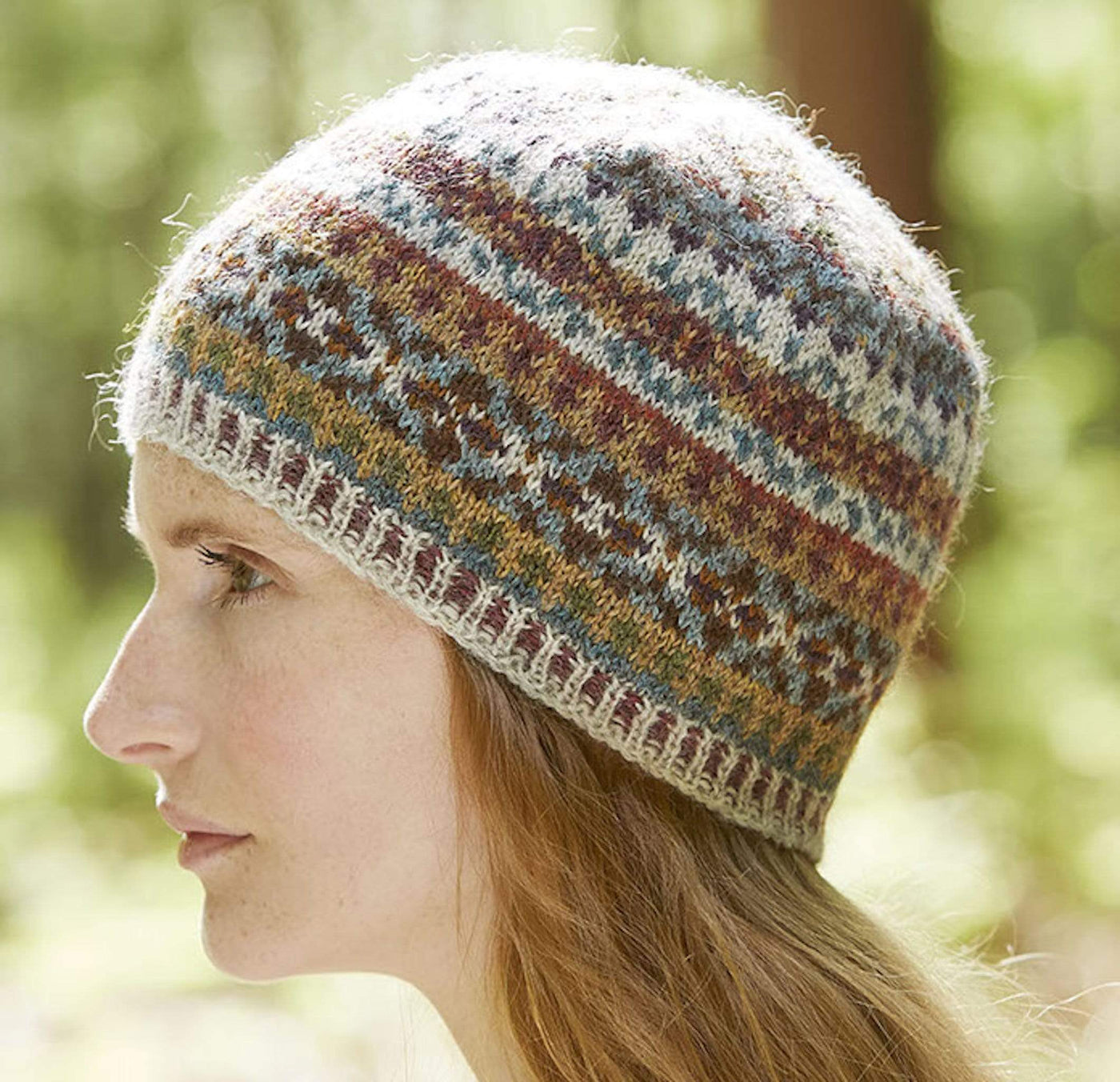 A woman wears the Walnut Tam colorwork hat knit with British Breeds yarn.