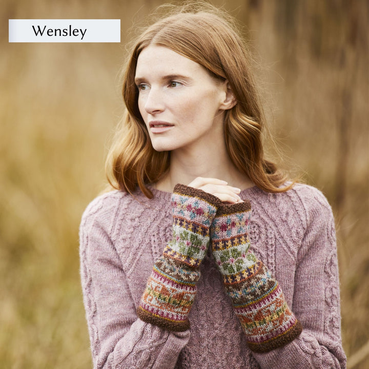 Female model wearing allover colorwork fingerless mitts design, Wensley, from Westmorland book by Marie Wallin.