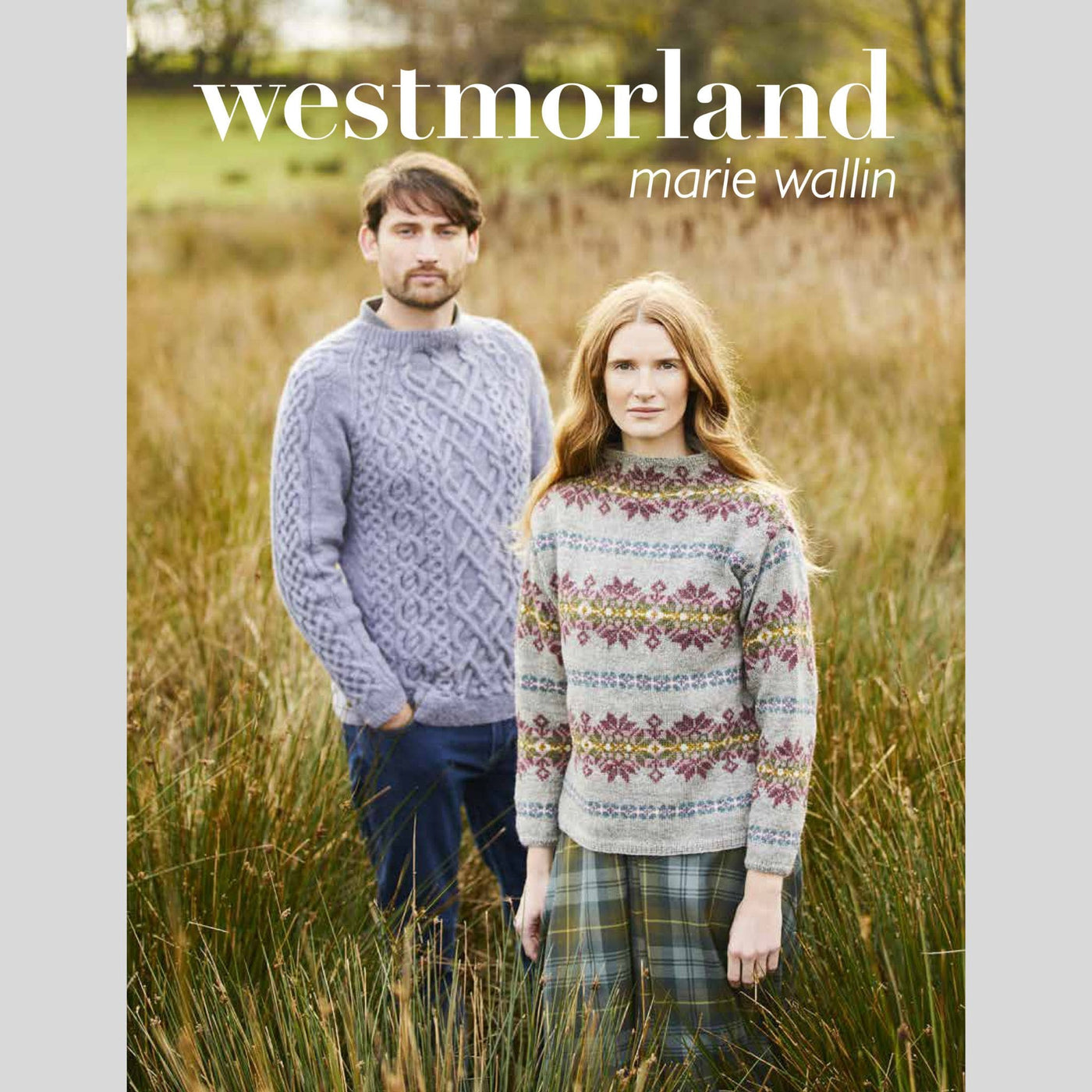 Front cover of Weslmorland: Marie Wallin book shows two models standing in grassy field. Male model wearing a textured grey pullover sweater and female wearing an allover colorwork pullover sweater.