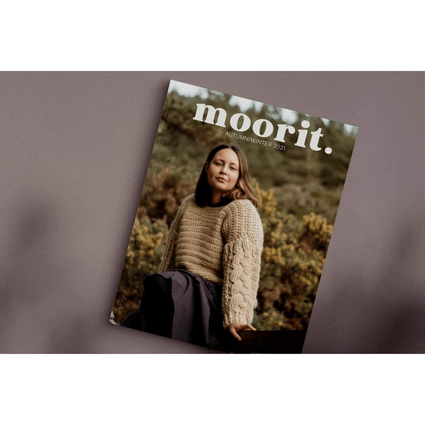The Woolly Thistle Moorit Magazine - Issue 1 Autumn/Winter 2021 image from magazine showing cover with woman wearing beige knitted sweater