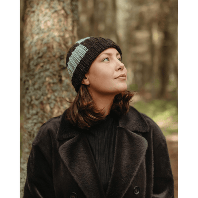 The Woolly Thistle Moorit Magazine - Issue 1 image from magazine showing woman wearing knitted brown and blue beanie 