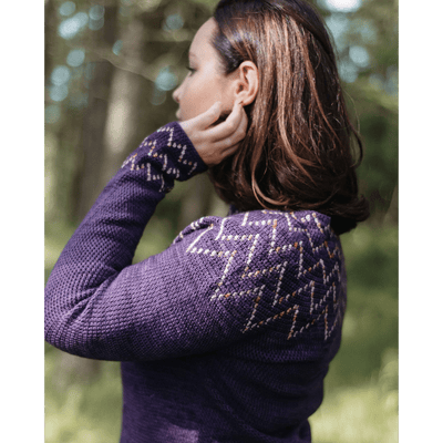 The Woolly Thistle Moorit Magazine - Issue 1 image from magazine showing woman wearing purple knitted sweater with white and brown details