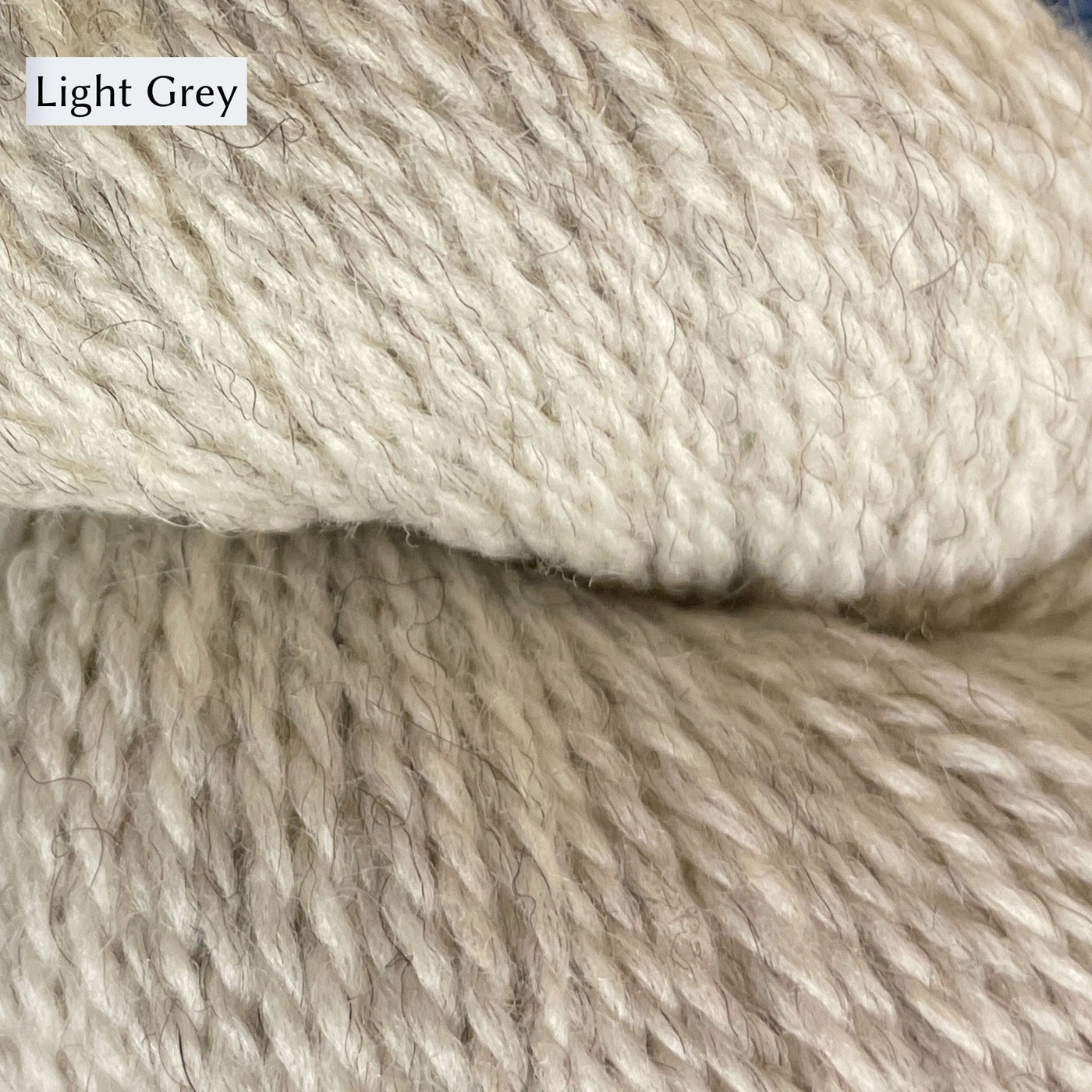 Oysters and Purls DK yarn, a Romney Merino blend. Colorway is Light Grey, a beige grey.