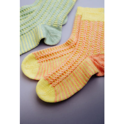 Colorful knits sock from Pom Pom Issue 44 that feature a textured patten on the top and striping throughout. 