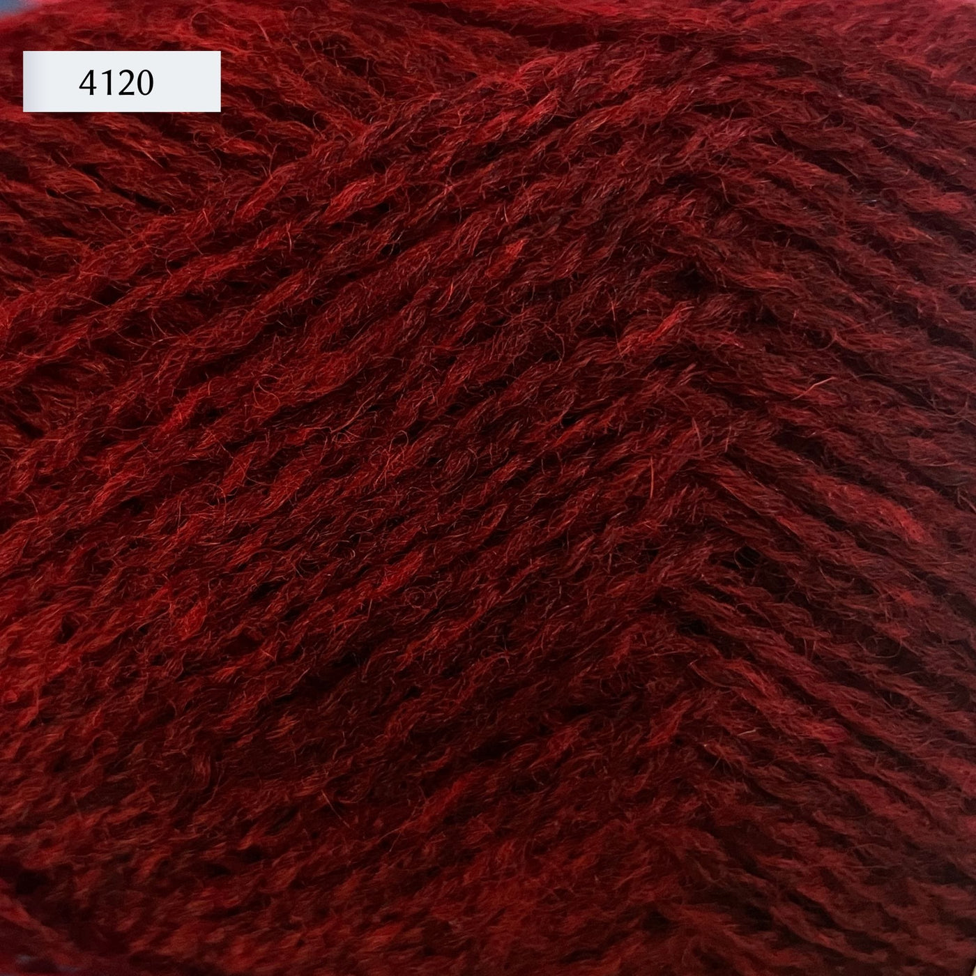 Rauma Finullgarn, a fingering/sport weight yarn, in color 4120, a heathered rich red