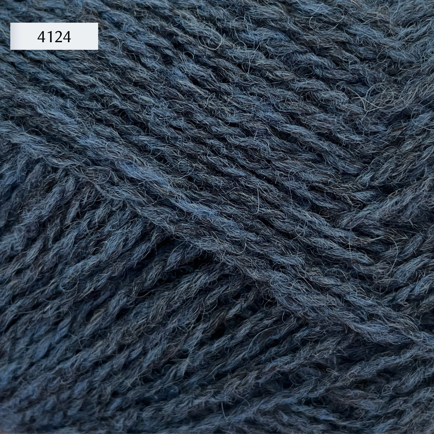 Rauma Finullgarn, a fingering/sport weight yarn, in color 4124, a heathered dark denim blue
