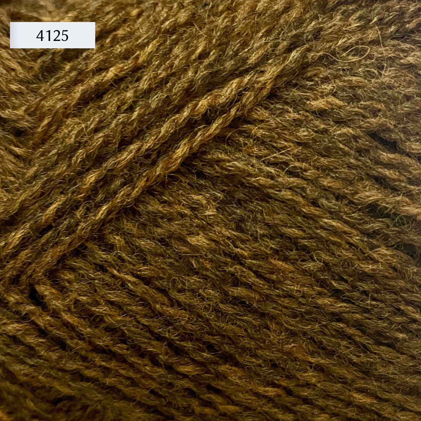 Rauma Finullgarn, a fingering/sport weight yarn, in color 4125, a heathered mustard gold