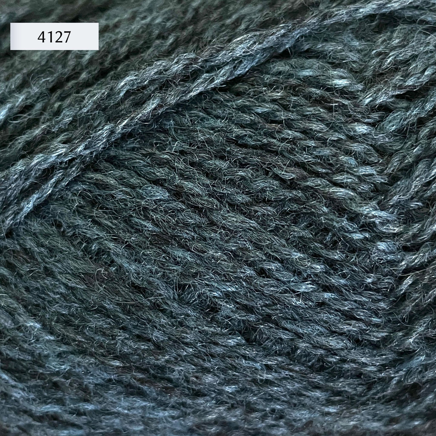 Rauma Finullgarn, a fingering/sport weight yarn, in color 4127, a heathered mid-tone petrol blue